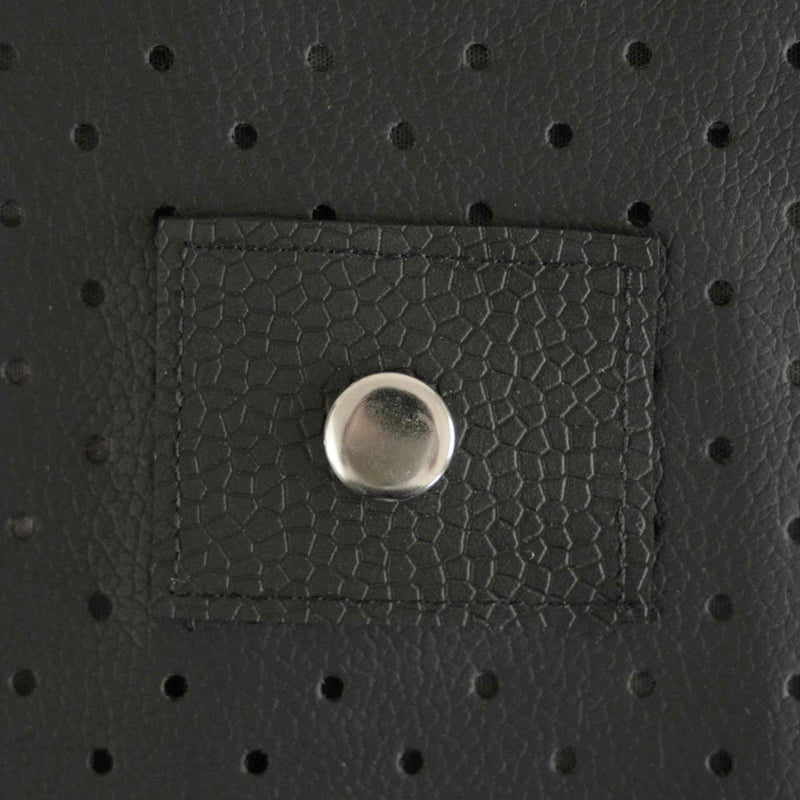 Close-up of a textured black PU leather patch with a metal button