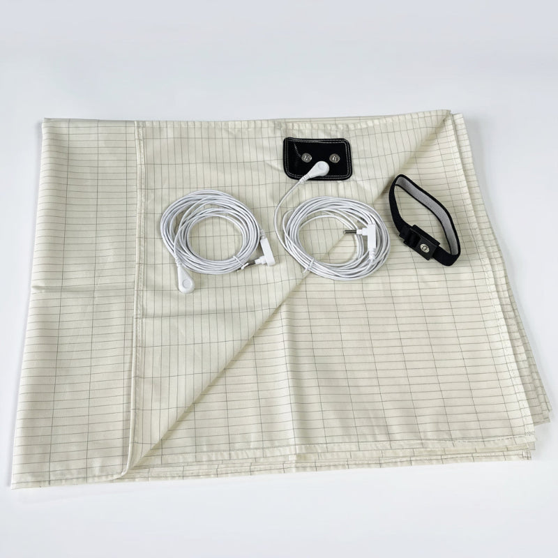 Earthing health kit with conductive fabric, cables, and earthing plates on a white background.