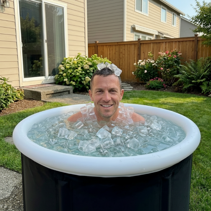 Man in an inflatable cold tub filled with ice cubes in a backyard setting.