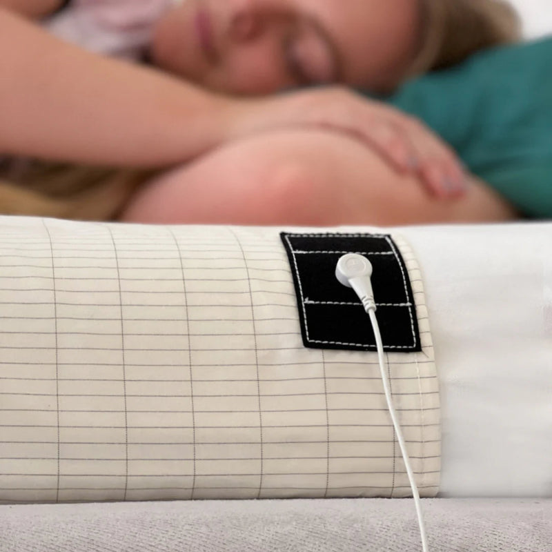 woman sleeping on top of the grounding sheet with the chord 