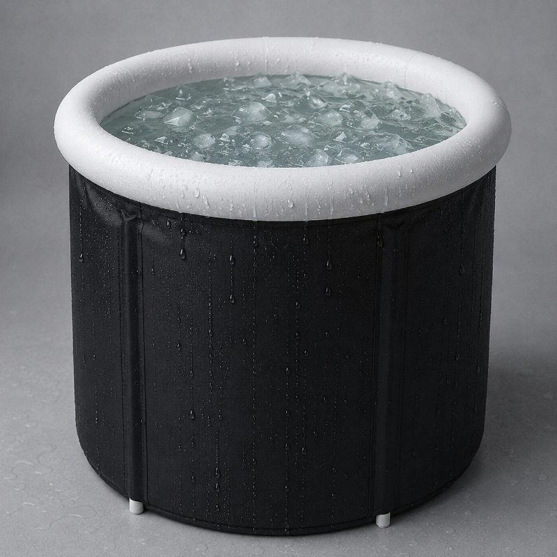 Black inflatable ice bath with water and ice on a gray background