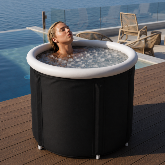 Woman relaxing in a portable ice bath on a wooden deck beside the ocean